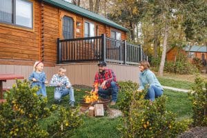 Couple and children around a campfire at Country Acres